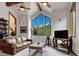 Bright living room with vaulted ceilings, wood beams, and mountain views from the beautiful, large picture windows at 322 Davis Ct, Breckenridge, CO 80424
