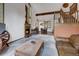 Cozy living room with a stone fireplace and an exposed beam ceiling at 322 Davis Ct, Breckenridge, CO 80424