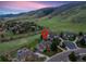 Aerial view of home with surrounding green space and mountain views at 87 Deerwood Dr, Littleton, CO 80127
