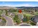 Aerial view of a neighborhood with mountain views and lush greenery at 87 Deerwood Dr, Littleton, CO 80127