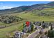 Aerial view of a neighborhood with mountain views and green hills at 87 Deerwood Dr, Littleton, CO 80127