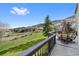 Spacious back deck with outdoor seating and scenic views of green space and mountains at 87 Deerwood Dr, Littleton, CO 80127