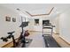 Well-lit basement featuring exercise equipment and a drop ceiling with wood trim at 87 Deerwood Dr, Littleton, CO 80127