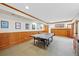 Finished basement with wainscoting and a ping pong table set up for recreational use at 87 Deerwood Dr, Littleton, CO 80127
