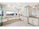 Luxurious bathroom with dual sinks, vanity, and soaking tub with a scenic view at 87 Deerwood Dr, Littleton, CO 80127