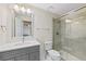 Bright bathroom features a modern vanity, framed mirror, and glass-enclosed shower at 87 Deerwood Dr, Littleton, CO 80127