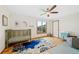 Bright Bedroom featuring wood floors, ceiling fan, neutral walls and a large picture window at 87 Deerwood Dr, Littleton, CO 80127