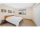 Bright bedroom featuring a comfortable bed, neutral walls, and a window with scenic views at 87 Deerwood Dr, Littleton, CO 80127