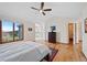 Bright bedroom features hardwood floors, ceiling fan, neutral walls and a large picture window at 87 Deerwood Dr, Littleton, CO 80127