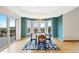 Inviting dining room with tray ceiling, large windows, and access to outdoor deck at 87 Deerwood Dr, Littleton, CO 80127