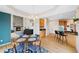 Open dining area with a fireplace, eat-in kitchen and hardwood floors at 87 Deerwood Dr, Littleton, CO 80127