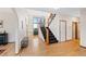 Bright foyer featuring hardwood floors, staircase with decorative railing, and large windows at 87 Deerwood Dr, Littleton, CO 80127