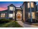 Stunning front entrance of home with brick and siding, arched doorway and walkway at 87 Deerwood Dr, Littleton, CO 80127