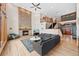 Open-concept living room with fireplace, hardwood floors, and staircase to upper level at 87 Deerwood Dr, Littleton, CO 80127