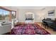 Open-concept living room featuring hardwood floors, large windows, neutral paint and an ornate area rug at 87 Deerwood Dr, Littleton, CO 80127