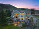 Two-story home with large deck and mountain views at sunset at 87 Deerwood Dr, Littleton, CO 80127