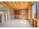 Unfinished basement showing concrete flooring, windows and wooden framing at 11648 Broken Arrow Dr, Conifer, CO 80433