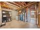 Unfinished basement with open layout, concrete floor, and utilities at 11648 Broken Arrow Dr, Conifer, CO 80433