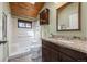 Cozy bathroom with granite countertops, wooden cabinets, and tile flooring at 11648 Broken Arrow Dr, Conifer, CO 80433