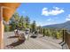 Relaxing outdoor deck area featuring comfortable seating and stunning mountain views at 11648 Broken Arrow Dr, Conifer, CO 80433