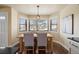 Cozy dining area with natural light and a view through large windows at 11648 Broken Arrow Dr, Conifer, CO 80433