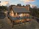 Charming exterior view of raised brown home with wraparound deck and mountain views at 11648 Broken Arrow Dr, Conifer, CO 80433