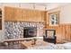 Close up of a stone fireplace with wood detailing at 11648 Broken Arrow Dr, Conifer, CO 80433