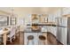 Bright kitchen featuring stainless steel appliances, granite countertops, and hardwood flooring at 11648 Broken Arrow Dr, Conifer, CO 80433