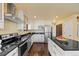 Modern kitchen with stainless steel appliances, granite countertops, and an island with seating at 11648 Broken Arrow Dr, Conifer, CO 80433