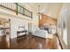 Open-concept living room with stone fireplace and loft area at 11648 Broken Arrow Dr, Conifer, CO 80433