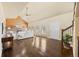 Spacious living room with wood floors, stone fireplace, and ample natural light at 11648 Broken Arrow Dr, Conifer, CO 80433