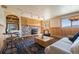 Cozy living room with stone fireplace and comfortable seating area at 11648 Broken Arrow Dr, Conifer, CO 80433