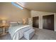 Bright main bedroom with a seating bench and view from a window at 11648 Broken Arrow Dr, Conifer, CO 80433