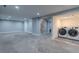 Finished basement area with a laundry area featuring modern washer and dryer units at 1601 S Glencoe St, Denver, CO 80222