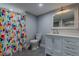 Stylish bathroom featuring a decorative shower curtain, vanity, and modern fixtures at 1601 S Glencoe St, Denver, CO 80222