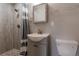 Stylish bathroom showcasing a tiled walk-in shower, a sleek mirror, modern fixtures and a sink at 1601 S Glencoe St, Denver, CO 80222