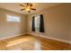 Bright bedroom boasts hardwood floors, a ceiling fan, and a large window providing natural light at 1601 S Glencoe St, Denver, CO 80222