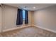 Bright, carpeted bedroom with window and accenting blue curtains at 1601 S Glencoe St, Denver, CO 80222