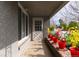 Cozy front porch adorned with colorful flowers, creating a welcoming entrance to the home at 1601 S Glencoe St, Denver, CO 80222