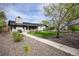 Landscaped front yard with vibrant greenery, flower beds, and a paved walkway leading to the home at 1601 S Glencoe St, Denver, CO 80222