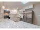 Well-lit kitchen with stainless steel appliances, granite countertops, and ample cabinet space at 1601 S Glencoe St, Denver, CO 80222