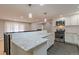 Bright kitchen featuring granite counters, a stainless steel oven, and an open layout into the living room at 1601 S Glencoe St, Denver, CO 80222