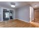 Sunlit living area featuring hardwood floors, a sliding glass door and a doorway into another room at 1601 S Glencoe St, Denver, CO 80222
