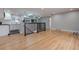 Open-concept living area features hardwood floors, recessed lighting and kitchen with white cabinets at 1601 S Glencoe St, Denver, CO 80222