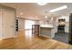 Spacious living room with hardwood floors seamlessly flowing into the kitchen with stainless steel appliances at 1601 S Glencoe St, Denver, CO 80222