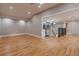 Sunlit living room boasts gleaming hardwood floors and an open floor plan with seamless flow to a modern kitchen at 1601 S Glencoe St, Denver, CO 80222
