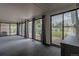 Bright sun room with multiple windows offering backyard views and access to the outdoor patio at 1601 S Glencoe St, Denver, CO 80222
