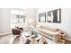 Bright and airy living room featuring large windows and modern decor at 1555 W 43Rd Ave, Denver, CO 80211