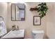 Stylish powder room with modern fixtures, decorative mirror, and neutral color scheme at 431 S Balsam St, Lakewood, CO 80226