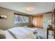 Bedroom with view to the outside, closet, and seating area at 431 S Balsam St, Lakewood, CO 80226